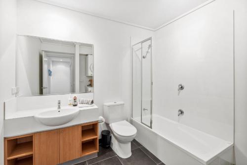 a bathroom with a sink and a toilet and a shower at Apartment 5 Pacific Apartments in Lorne