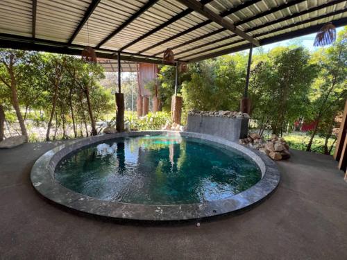 a large pool of water in a patio at The Breath Chiangdao in Chiang Dao