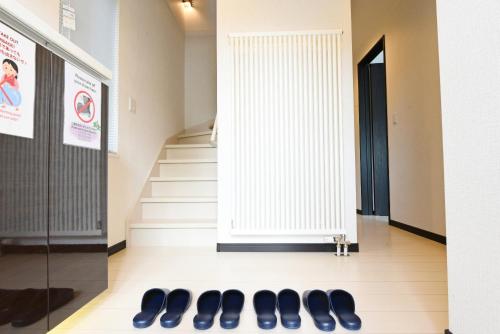a row of shoes on the floor in a hallway at Teinehoncho Ikkenya in Sapporo