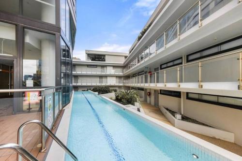a large building with a swimming pool in the middle at Ocean View Modern 2 bedroom with Parking in St Kilda in Melbourne
