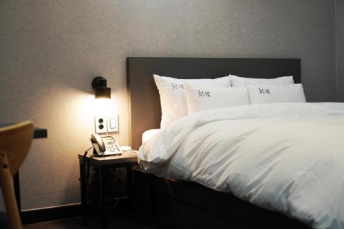 Ένα ή περισσότερα κρεβάτια σε δωμάτιο στο Hotel Cheongdam