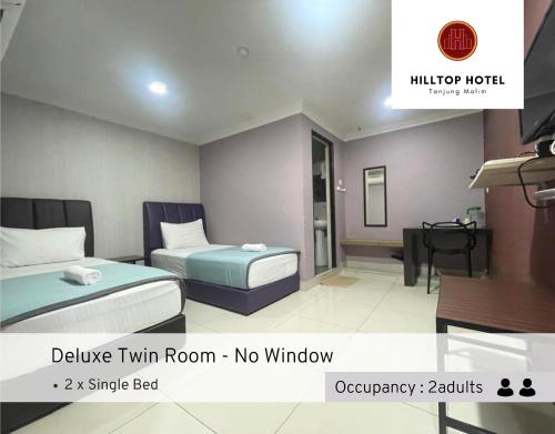 Postel nebo postele na pokoji v ubytování Hilltop Hotel Tanjung Malim