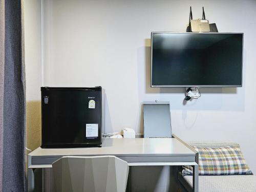 a desk with a computer and a monitor on it at Jeonju Hostel in Jeonju