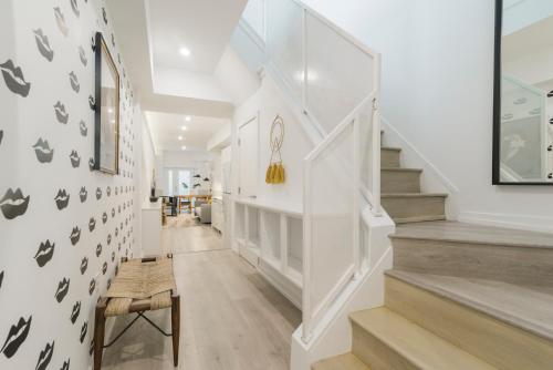 a staircase in a home with white walls and a stair case at Abode XS House Stunning Architectural Flat in Philadelphia