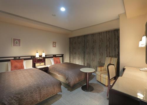 Postel nebo postele na pokoji v ubytování Sasebo Washington Hotel