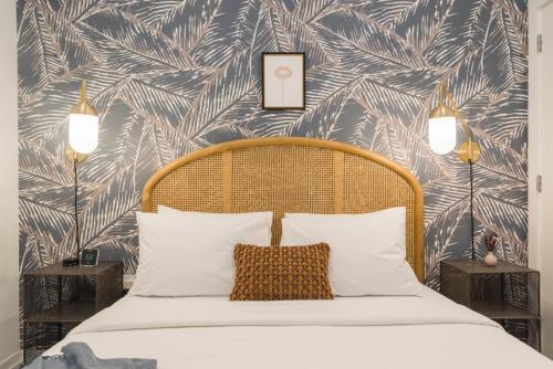 a bedroom with a bed with a tropical wallpaper at Abode XS House Stunning Architectural Flat in Philadelphia