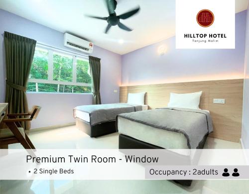 Postel nebo postele na pokoji v ubytování Hilltop Hotel Tanjung Malim