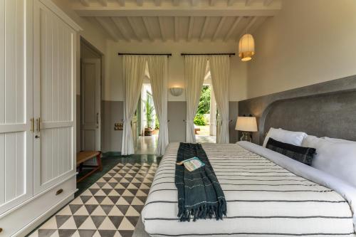 a large bedroom with a large bed in a room at La Rozalia, Exquisite 4 BHK Villas with Large Pool, Garden, Dedicated Caretaker, Terrace, 2 mins from the famous Dear Zindagi Road in Mapusa
