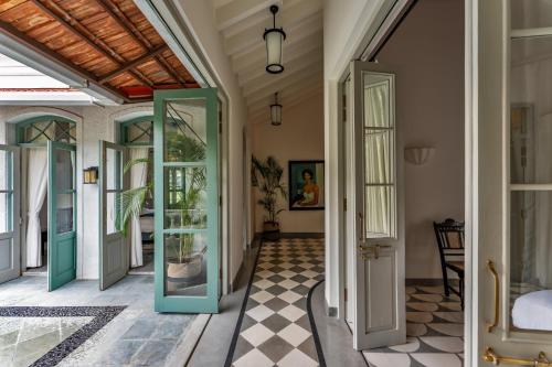 an open door in a room with a tile floor at La Rozalia, Exquisite 4 BHK Villas with Large Pool, Garden, Dedicated Caretaker, Terrace, 2 mins from the famous Dear Zindagi Road in Mapusa