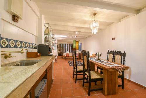 a kitchen with a table and chairs and a dining room at Ohana House @ 15 Kuli in Melaka