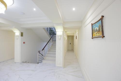 a hallway with stairs and a painting on the wall at Beksaroy in Samarkand