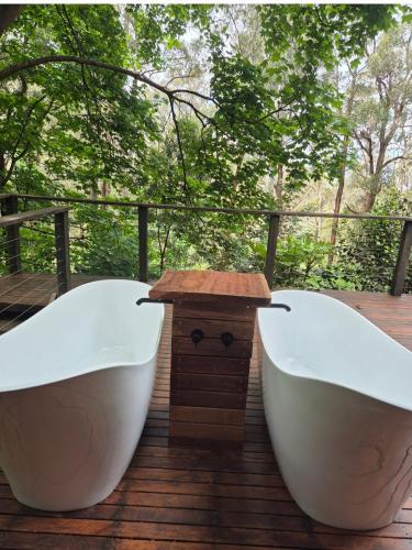 two white bath tubs sitting on a deck at Romantic Getaway - 2 luxe outdoor baths in Mount Macedon