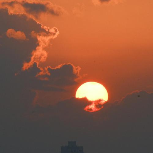 a sun setting in the sky with clouds at Xiamen Mingshu Shanqiu Homestay in Xiamen