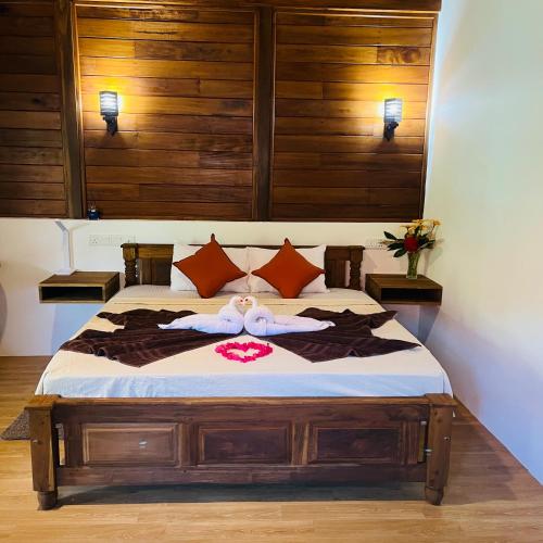 a bedroom with a bed with two towels on it at Hanguk Lanka Lagoon Villa in Tangalle