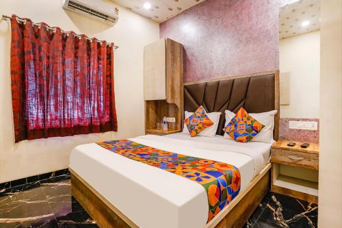 a bedroom with a bed and a window at FabExpress The United - Nr Mumbai International Airport in Mumbai