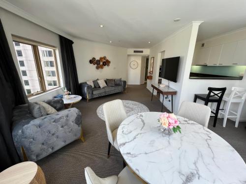a living room with a marble table and a couch at Fancy home with water view in the rocks in Sydney