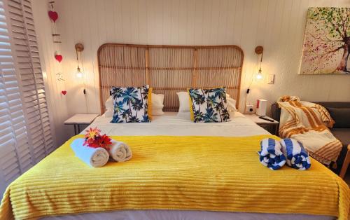 a bedroom with a large bed with towels on it at Private Hotel Studio Apartment - Full Kitchen in Port Douglas