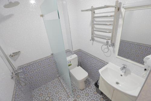 a bathroom with a toilet and a sink and a shower at Beksaroy in Samarkand
