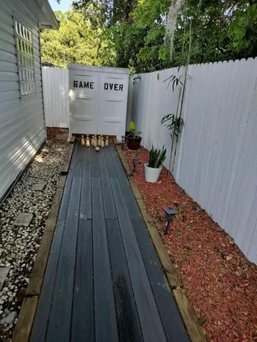 a backyard with a wooden deck and a fence at Charming 4-Bedroom Family Haven in Saint Augustine