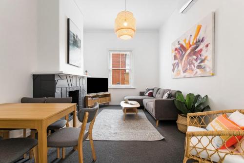 a living room with a couch and a table at Salty Pines - 3BR House Glenelg South in Glenelg