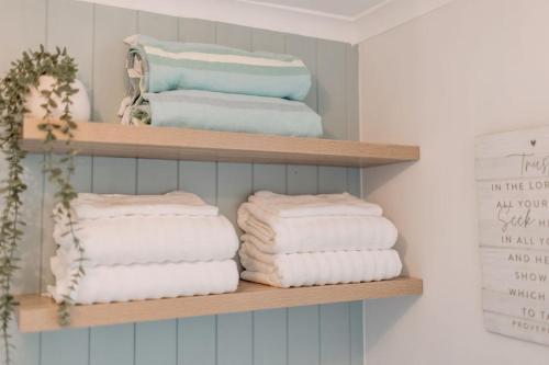 a bunch of towels are sitting on a shelf at River Sands Apartments in Maroochydore