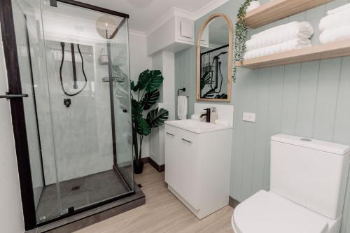 a bathroom with a shower and a toilet and a sink at River Sands Apartments in Maroochydore