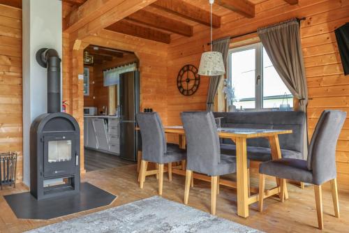 a kitchen and dining room with a wood stove at Gemütliches Holzhaus in Gamlitz! in Gamlitz