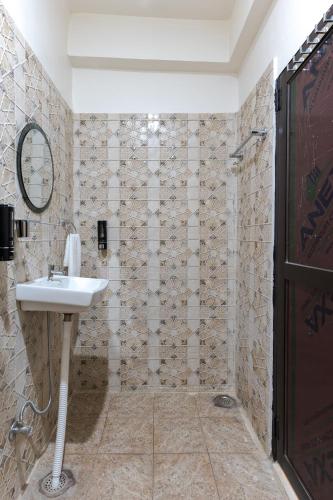 a bathroom with a sink and a shower at Divine Stays in Jaipur