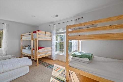 a room with two bunk beds and a couch at Zen Whisper in the Woods in Groveland