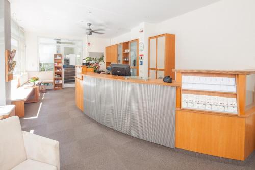 an office with a reception desk and a lobby at City Hotel Freiburg in Freiburg im Breisgau