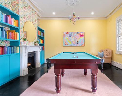 a room with a pool table and a fireplace at The Evelyn in Melbourne