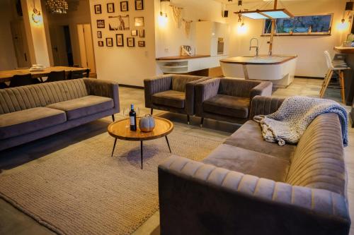 a large living room with couches and a table at Urban Jungle Room rundum Entspannung mit Sauna in Troisdorf