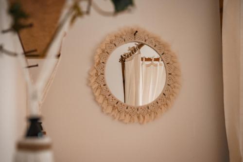 a mirror hanging on a wall in a room at Urban Jungle Room rundum Entspannung mit Sauna in Troisdorf