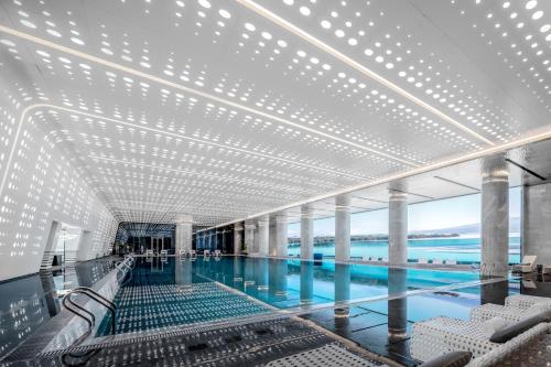 a swimming pool on a cruise ship with a large ceiling at Suzhou International Conference Hotel in Suzhou