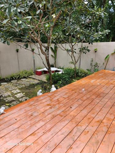 a wooden deck with a tree on top of it at Terrua Main Ten Villa Garden in Suan Phung