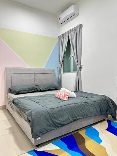 a bedroom with a bed and a window with avertisement at Bayu Temiang Homestay in Seremban