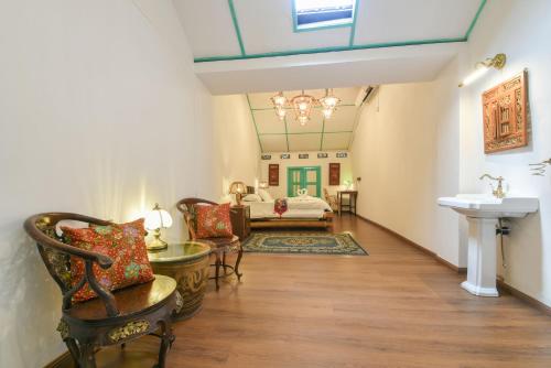 a hallway with a living room with a couch and a sink at Ohana House-H3 in Melaka