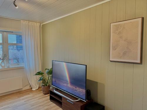 a living room with a flat screen tv on a wall at Villa in central Narvik! in Narvik