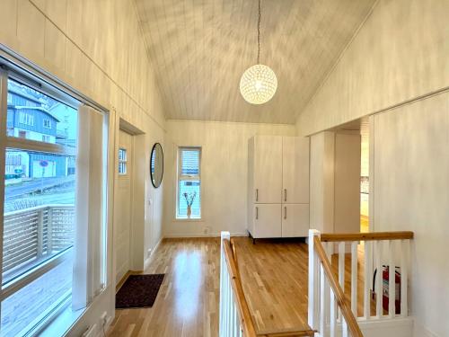 a living room with a staircase and a large window at Villa in central Narvik! in Narvik