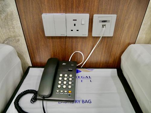 a telephone sitting on top of a box at Pantai Regal City Hotel in Kuantan
