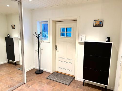 a room with a door and a plant in it at Villa in central Narvik! in Narvik