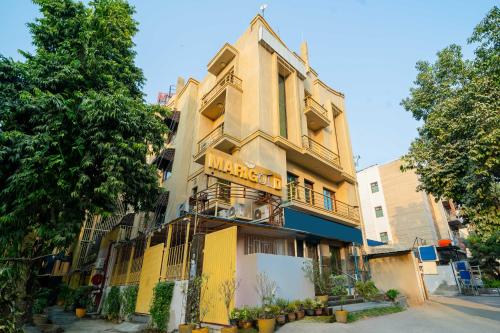 a yellow building with a sign on it at Treebo Marigold in New Delhi