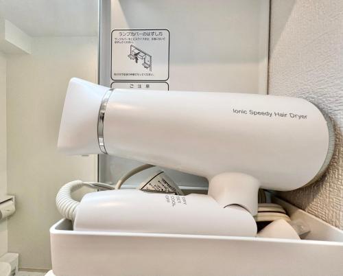 a white toilet in a bathroom with a sign on it at 君の家AOTO#Haneda&Narita Access#Free reserved parking in Tokyo