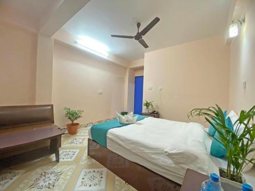 a bedroom with a bed and a ceiling fan at Hotel Resunga Arjun in Kathmandu