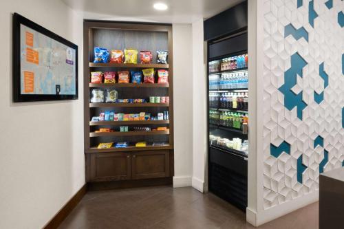 a store aisle with a refrigerator with food at Hyatt Place Mystic in Mystic
