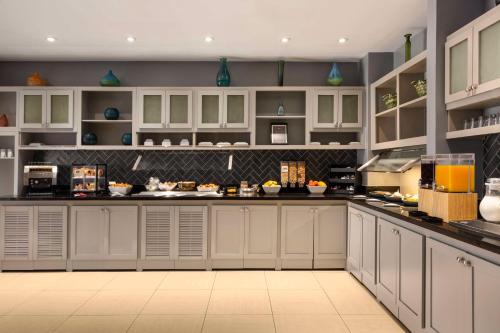 a large kitchen with white cabinets and appliances at Hyatt Place Nashville/Hendersonville in Hendersonville