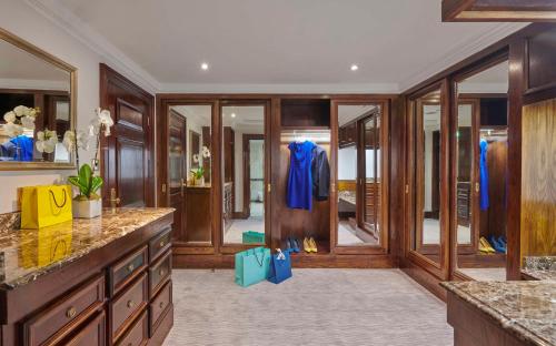 a large kitchen with wood paneling and a hallway with glass doors at Hyatt Regency London - The Churchill in London