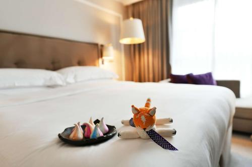 a hotel room with a bed with a stuffed fox on it at Hyatt Regency London - The Churchill in London