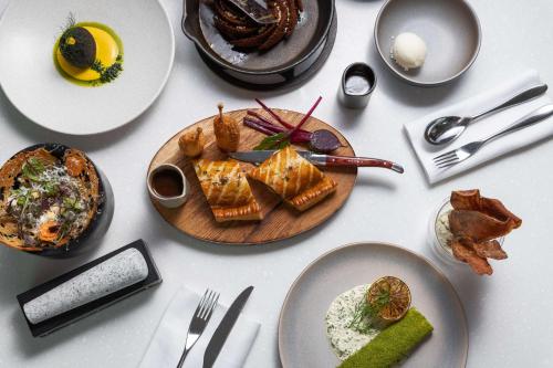 a white table with plates of food on it at Hyatt Regency London - The Churchill in London