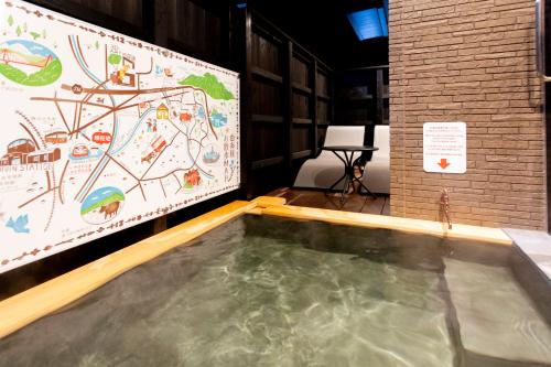 a large screen with a large pool of water in a room at 貸し切り宿 世紡 YOTSUMUGI sakazuki and iyasaka in Yufuin